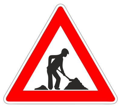 Dopravná značka upozorňujúca na práce na ceste, trojuholníková značka s červeným okrajom a čiernou siluetou muža vykonávajúceho zemné práce.